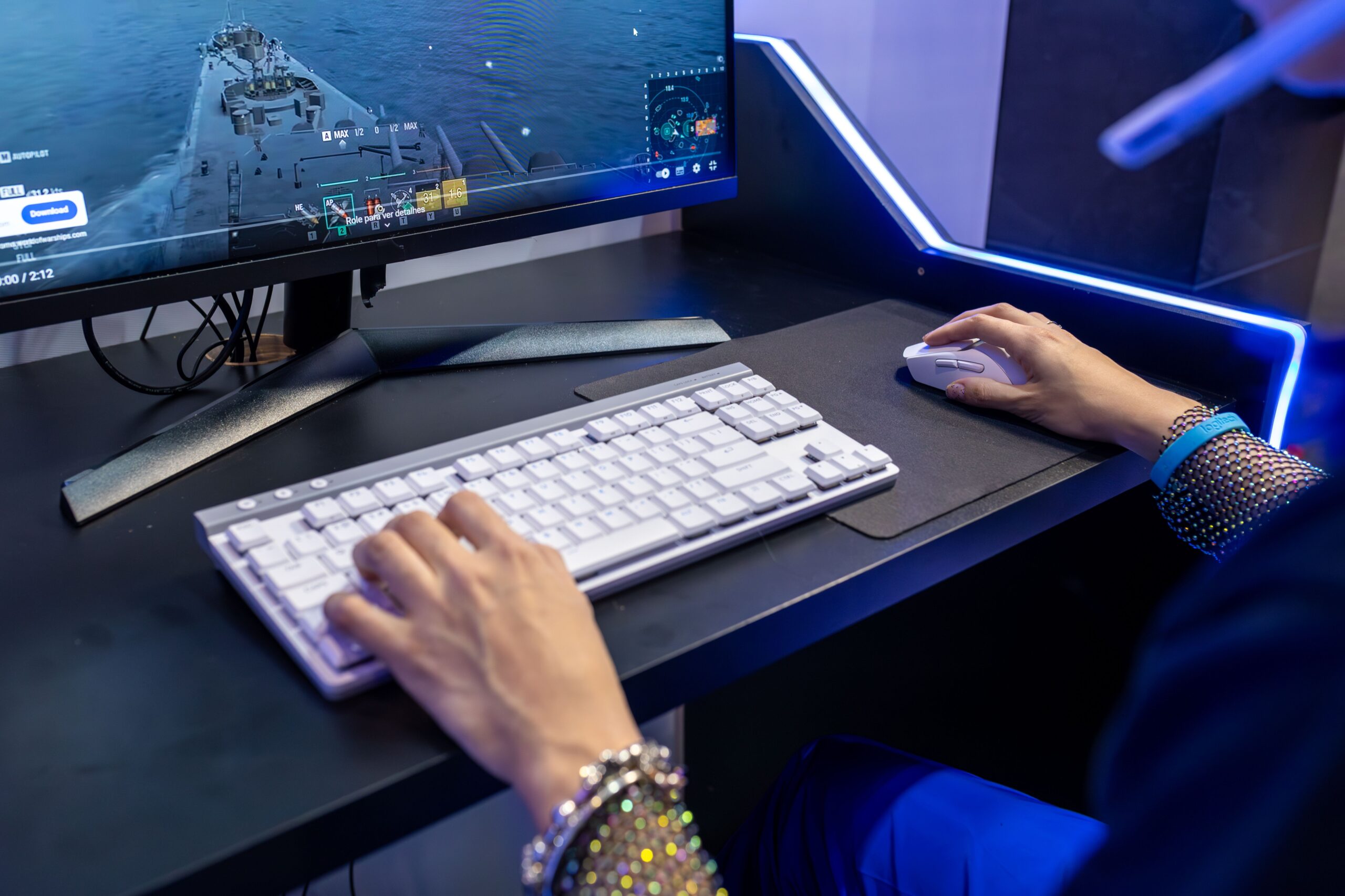 Close-up of a person gaming on a PC with a colorful setup and gaming accessories.